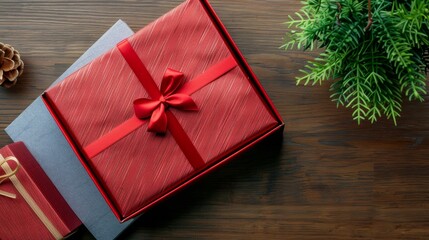 Wall Mural - Elegant red gift box with bow on wooden background