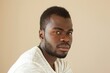 © senyumanmu - portrait of adult Black man looking at camera in studio
