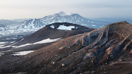 Wall Mural - View of Mutnovsky volcano from the crater of Gorely volcano. Kamchatka peninsula, Russia. Aerial drone view. Beautiful landscape at sunrise.
