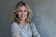 © senyumanmu - Portrait of confident smiling middle aged woman with crossed arms