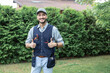 © Vitaliy - Portrait of young handsome electrician in uniform standing on the grass after finishing work on the backyard