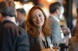 © Iftikhar alam - A woman holding a glass of wine amidst a lively party atmosphere, A woman networking at a business conference, surrounded by industry professionals