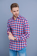 © be free - Man isolated on grey. Millennial man wearing checkered shirt. Casual style of millennial man. Portrait of young man in casual style shirt. Stylish face portrait of unshaven guy. Checkered fashion