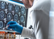 © Westend61 - Scientist removing medical sample and checking MRI report in hospital