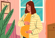 © Westend61 - Pregnant woman touching belly and standing at home