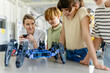 © Halfpoint - Children learning robotics in Elementary school. Young students programming, building robot in after school robotics club. Field trip to real robotics laboratory.