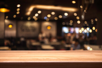 Wall Mural - Empty wooden table in front of abstract blurred background of coffee shop