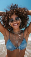 Wall Mural - A young woman wearing glasses and headphones by the seaside