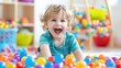 © Rina - Joyful Toddler in a Ball Pit
