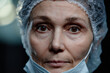 © Seventyfour - Extreme closeup portrait of female surgeon looking at camera with dramatic light in hospital