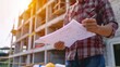 © Attasit - civil engineer working with documents on construction site, building and home renovation, professional foreman at work