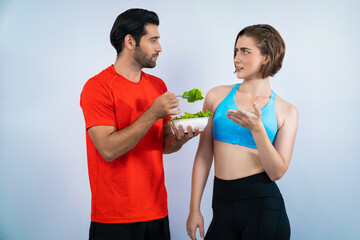 Wall Mural - Full body length gaiety shot athletic and sporty young couple with healthy vegan food in standing posture on isolated background. Healthy active and body care by vegetarian lifestyle.