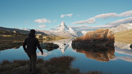 Wall Mural - Traveler man standing and enjoying on Stellisee Lake with Matterhorn mountain in the morning at Switzerland