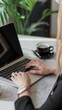 © Nicolai - Close up of hands typing on a laptop keyboard in an office, working with a computer at a table