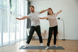 © standret - Man and woman are doing yoga exercises at home