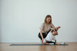 © standret - Helping the kid. Young woman with little girl are doing yoga at home