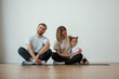 © standret - Cheerful people. Family of mother, father and daughter are doing yoga at home