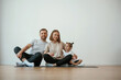 © standret - Cheerful people. Family of mother, father and daughter are doing yoga at home