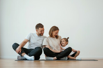 Sticker - Family of mother, father and daughter are doing yoga at home