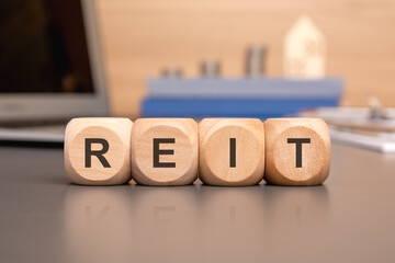 Wall Mural - reit written on wooden cube with keyboard, calculator, chart, coins. business concept