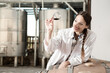 © caftor - Female employee in white robe posing at winery