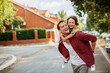 © Geber86 - Joyful father giving piggyback ride to son on suburban street