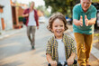 © Geber86 - Father and grandfather teaching young boy to ride a bike on residential street