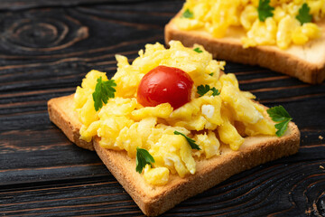 Wall Mural - Healthy vegetarian breakfast . Scrambled eggs toast with cherry tomatoes and parsley