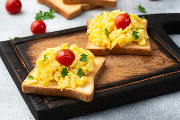 Wall Mural - Healthy vegetarian breakfast . Scrambled eggs toast with cherry tomatoes and parsley