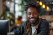 © fotofabrika - Smiling Black Man With Dreadlocks in Cafe