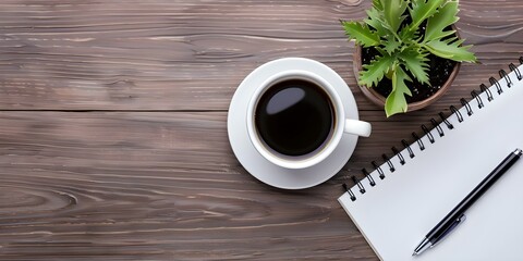 Wall Mural - Topdown view of desk with coffee mug and houseplant ideal for work. Concept Topdown Photography, Desk Essentials, Work From Home Setup