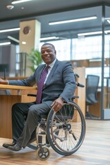 A handsome man in a wheelchair, dressed elegantly in a suit, smiling joyfully in an office setting.