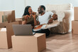 © standret - Celebration, eating pizza. African American couple are moving into new house