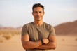 © Markus Schröder - Portrait of a satisfied indian man in his 40s dressed in a casual t-shirt isolated on backdrop of desert dunes