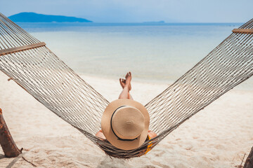 Traveler asian woman relax and travel in hammock on summer beach at Koh Rap Samui in Surat Thani Thailand