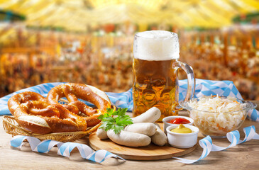 Wall Mural - Oktoberfest food. Mug of beer, bavarian sausages and pretzels on beer tent background