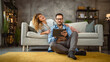 © Miljan Živković - Boyfriend sit on the floor use tablet while girlfriend lie and hug him