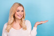 © deagreez - Photo of lovely cheerful woman wear trendy white clothes hold empty space isolated on blue color background