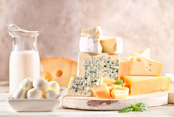 Poster - assorted hard and soft cheeses on a wooden table