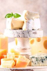 Poster - assorted hard and soft cheeses on a wooden table