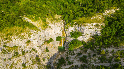 An aerial view of the stunning Val Rosandra Nature Reserve, showcasing its beautiful hiking trails that wind through lush greenery and rugged landscapes. Located near Trieste, Italy