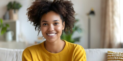 Wall Mural - A young woman with a smile on her face lounges on a couch in a living room. Concept Indoor, Candid, Lifestyle, Casual, Relaxing