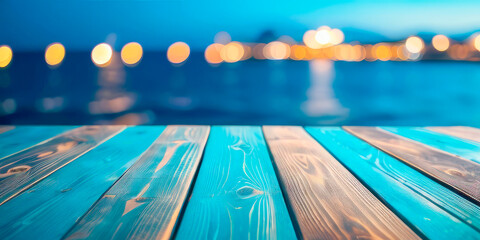 the surface of a wooden blue table for advertising products against the background of blurred night lights of the sea beach