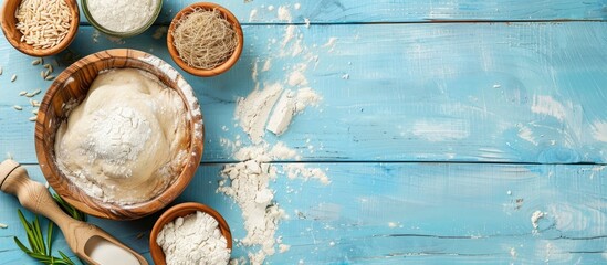 Canvas Print - A blue wooden table displays compressed yeast near dough ingredients, with a perfect copy space image.