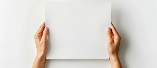 Poster - Hands clasping an empty paper with room for text, on a white background for a copy space image.