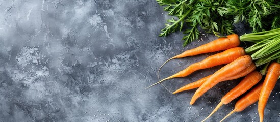 Sticker - A healthy eating concept featuring fresh carrots on a gray background, creating a frame of vegetables on a table in a raw and organic food copy space image.