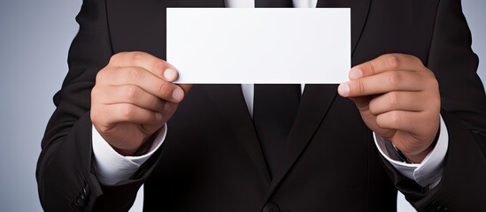 Aufkleber - A businessman is displaying a white card with blank space for text or images.