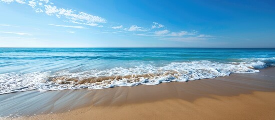 Aufkleber - Scenic beach with a clear blue sky and gentle waves along the shore, perfect for a copy space image.