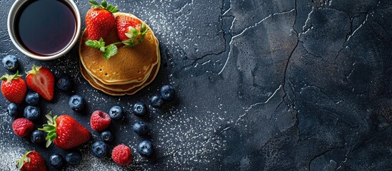 Wall Mural - Breakfast featuring blueberry and strawberry pancakes on a stone table backdrop with a spacious area for text or images.