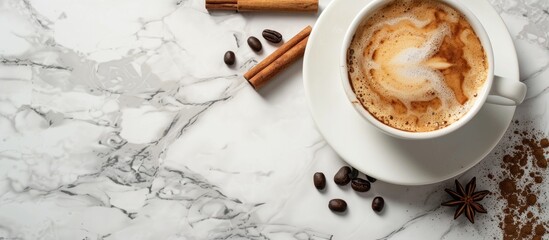 Aufkleber - Top view of a cup with coffee and cinnamon sticks on a marble surface providing copy space image.
